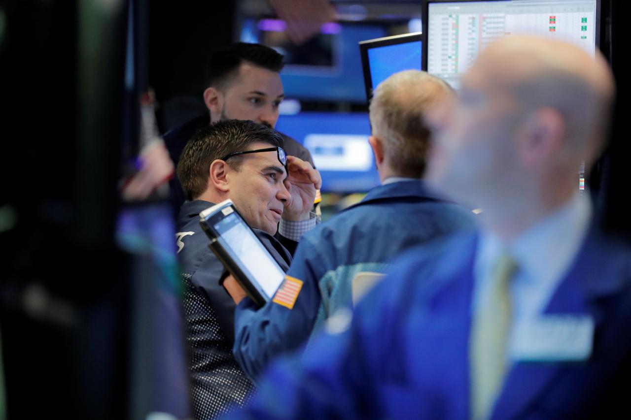 Traders work on the floor of the New York Stock Exchange shortly after the opening bell in New York